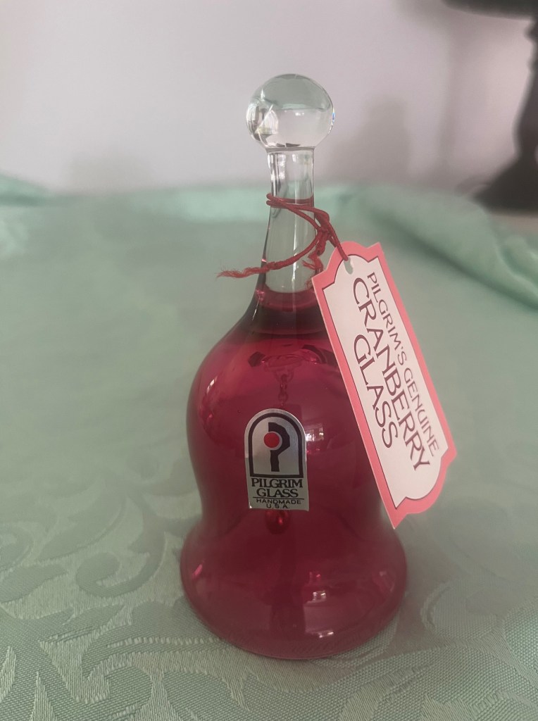 A Pilgrim Glass dinner bell in cranberry