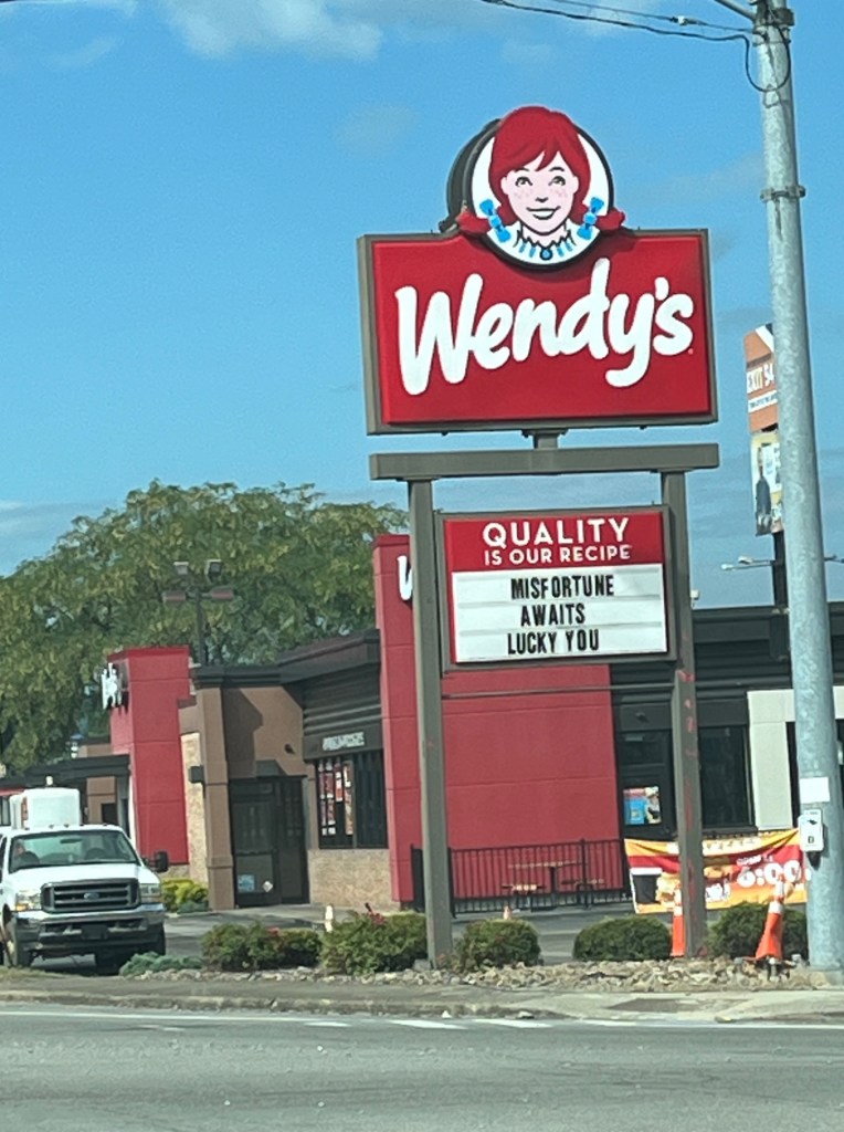 Wendy's fast-food restaurant sign that says Misfortune Awaits Lucky You